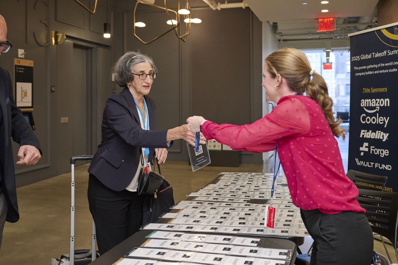 The event team welcoming a guest at registration